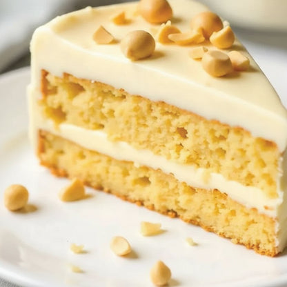 Slice of cake with white frosting and peanut pieces on a white background, with a '1KG' label.
